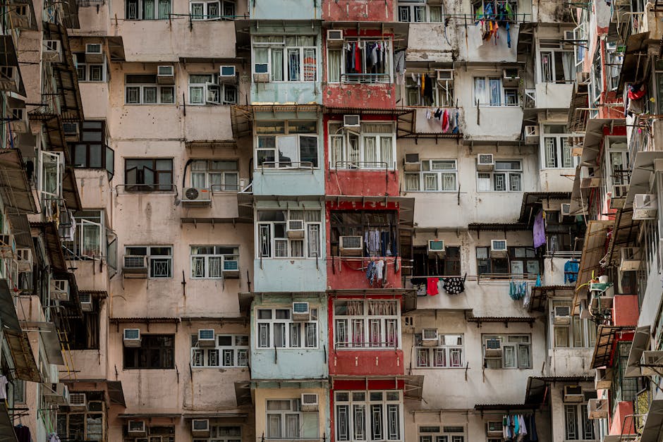 Detailed view of a densely populated apartment building in Hong Kong, showcasing urban life.